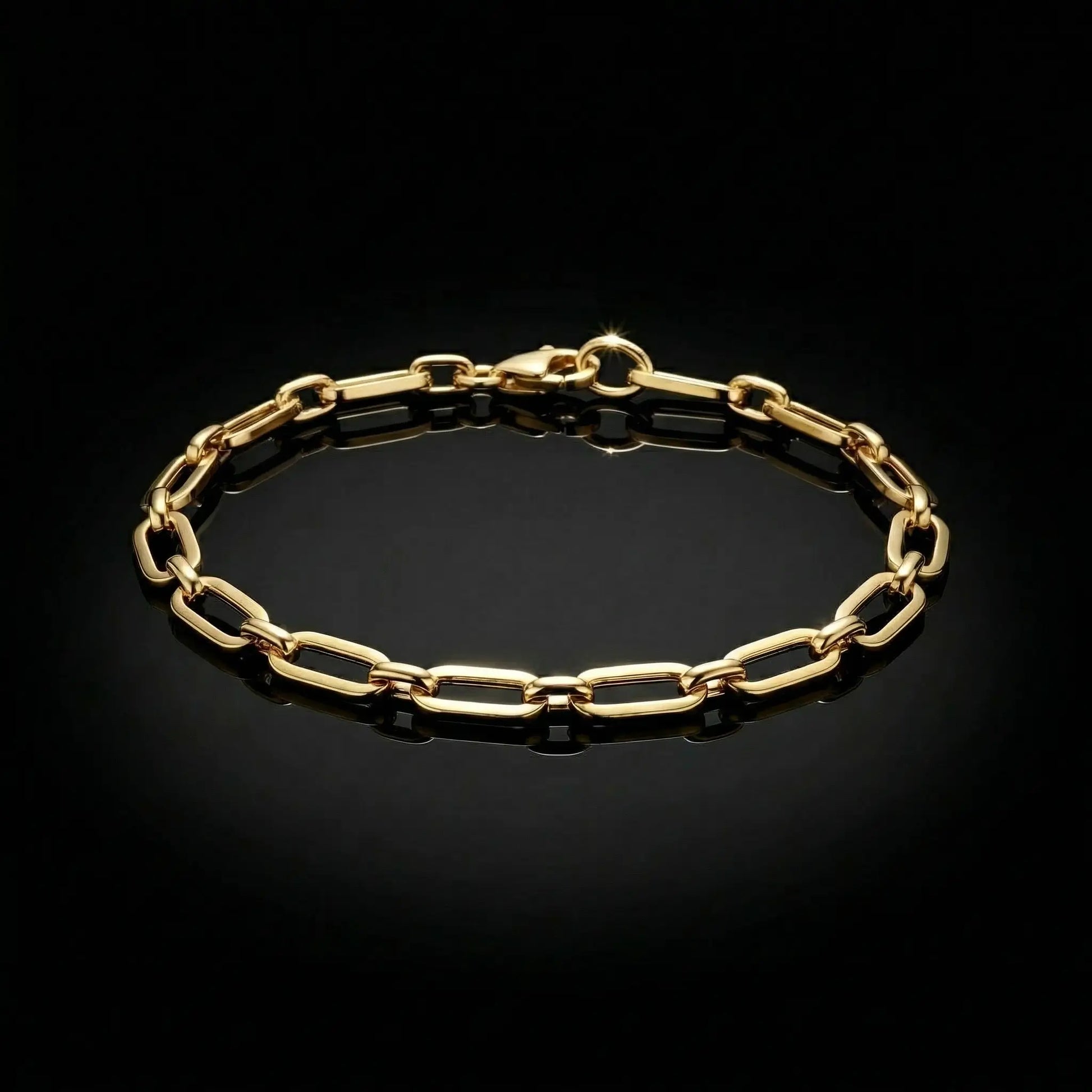 Yellow golden womens bracelet with paperclip links laying flat on a mirrored surface.
