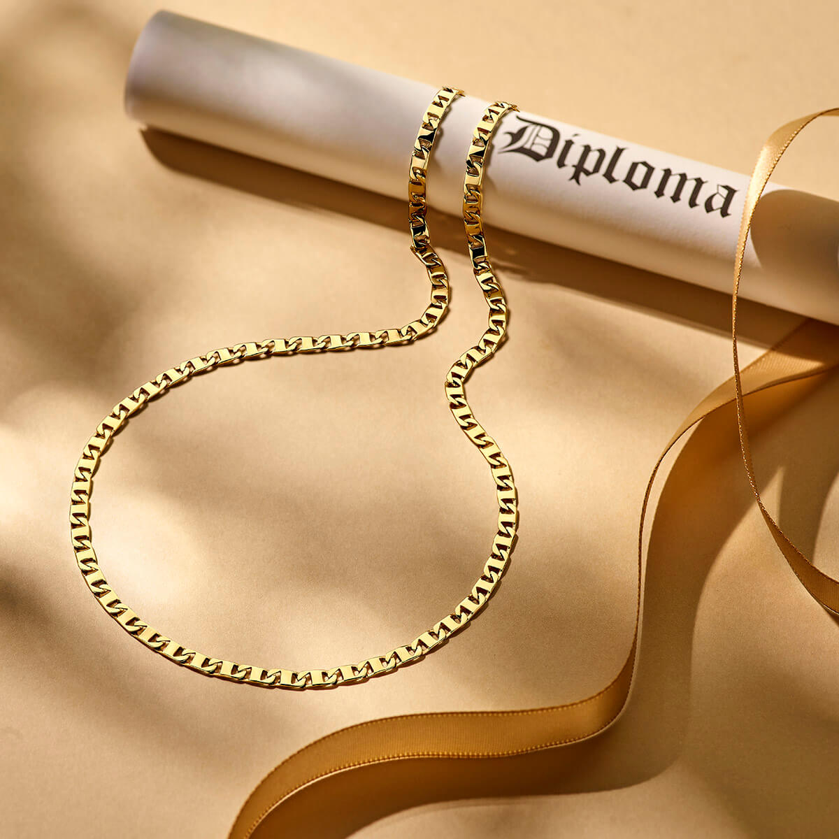 Golden chain laying on asuede surface.
