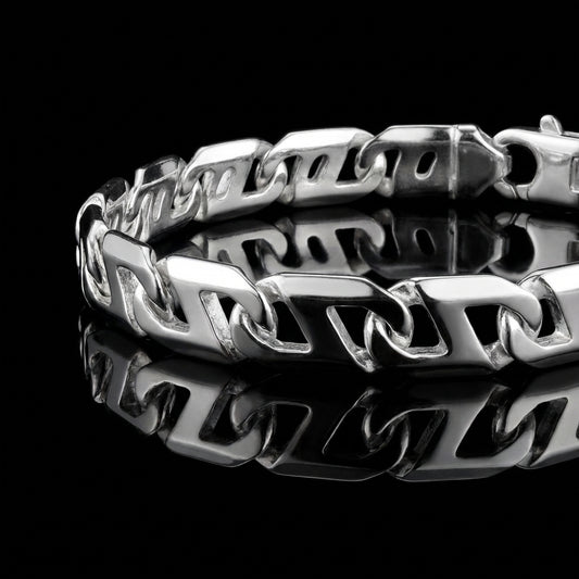 Product photo of a silver mens bracelet laying flat on a mirrored surface.