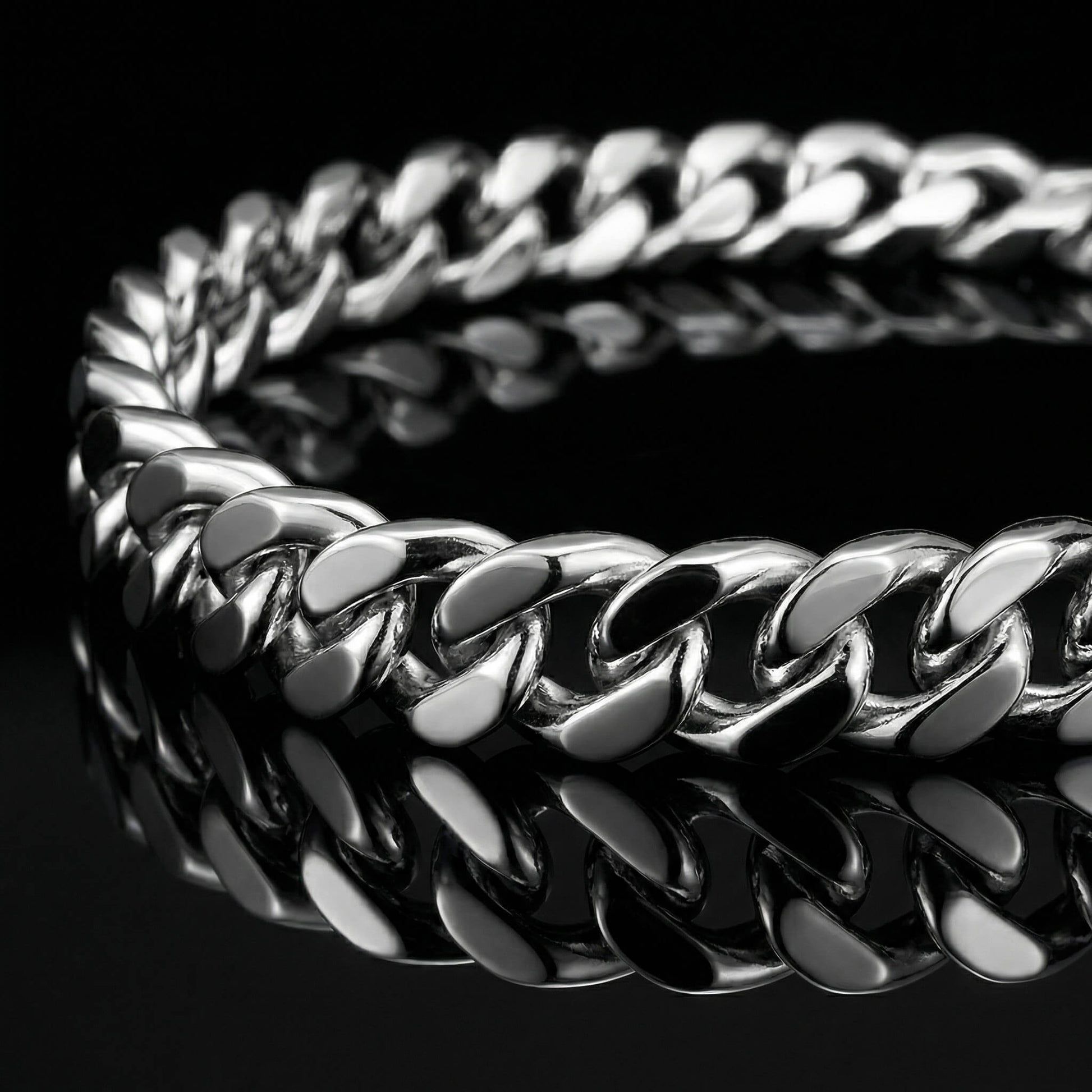 SIlver mens bracelet gourmette link laying flat on mirrored surface.