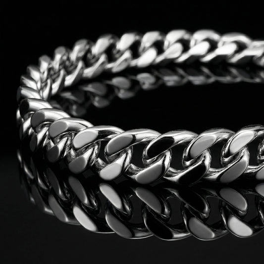 SIlver mens bracelet gourmette link laying flat on mirrored surface.